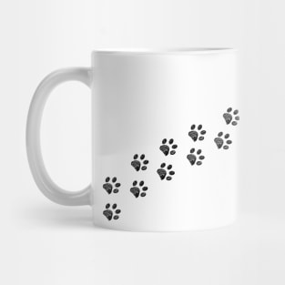 White paw prints trace Mug